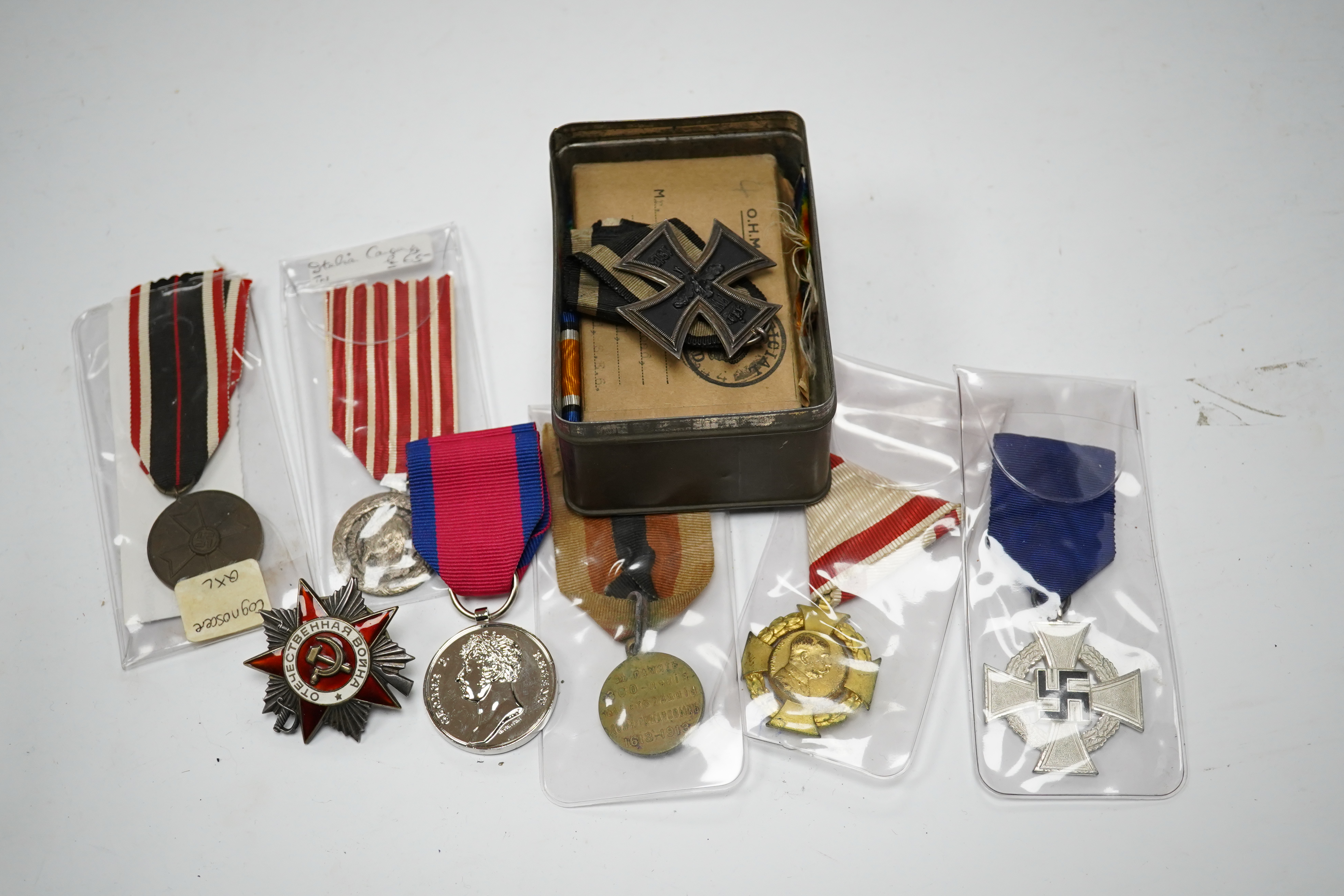 Fifteen British, German, etc. military medals including; a First World War medal pair to DVR. A.E. Hooker. R.A., a boxed WWII Defence Medal, a 1914 Second Class Iron Cross, a France Italian Campaign medal, a 1939 German